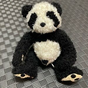 Panda stuffed animal by bamboo